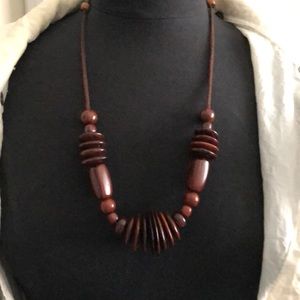 Mahogany various wood beads on adjustable string.
